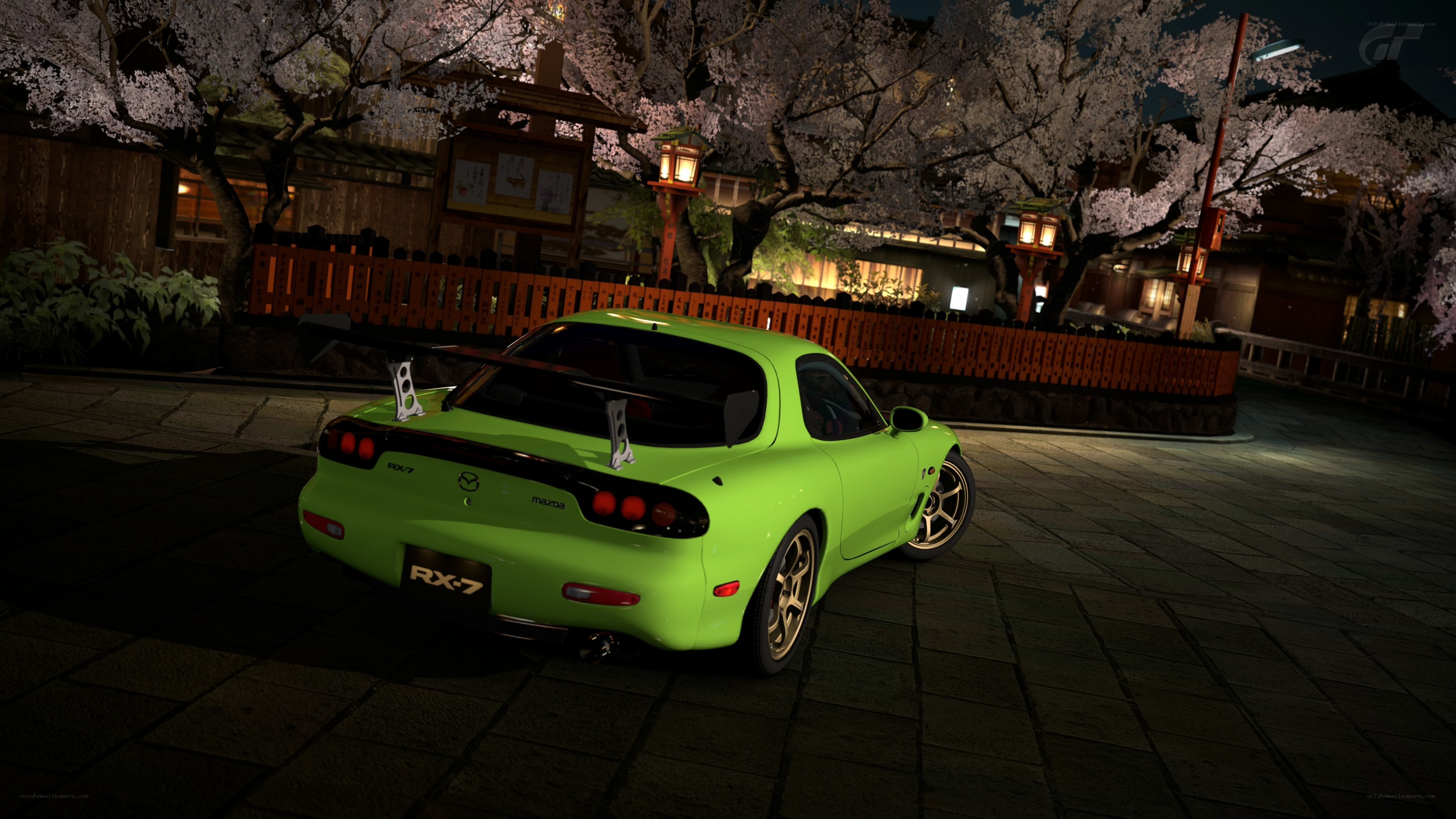 Green Mazda RX-7 at night