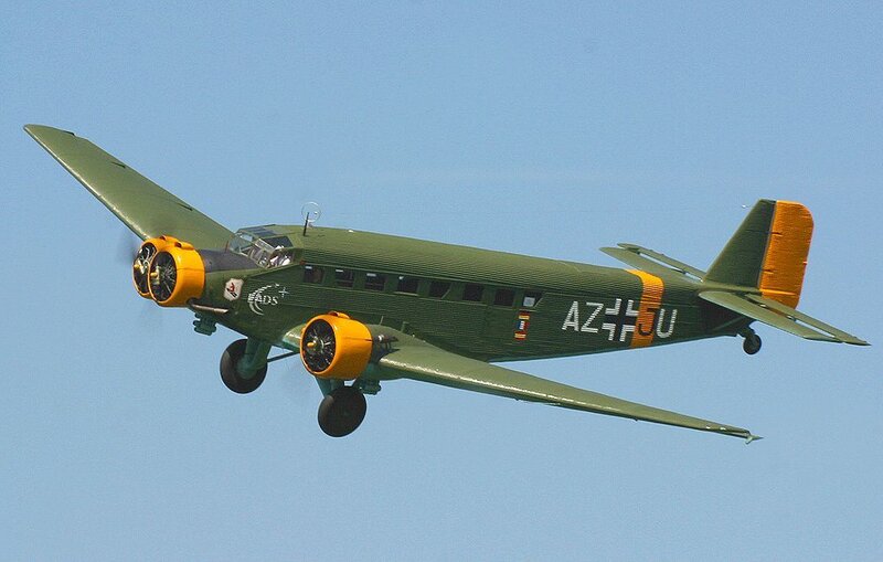 Green military aircraft in flight