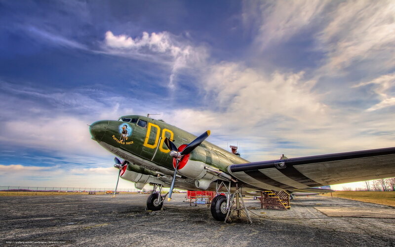 Green military aircraft on tarmac