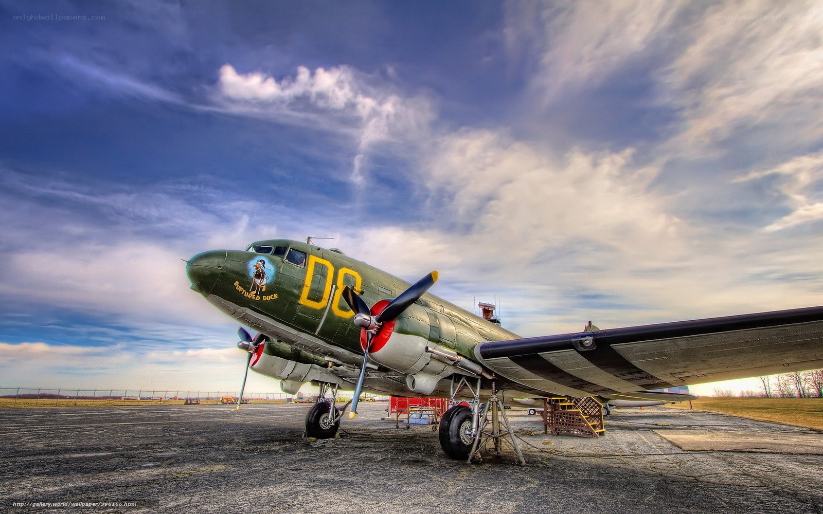 Green military aircraft on tarmac