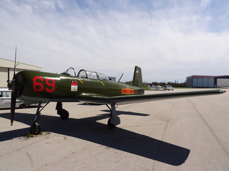 Green Military Airplane — Calm, Afternoon, Photograph, Hangar