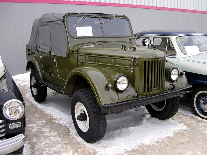 Green military jeep in snow