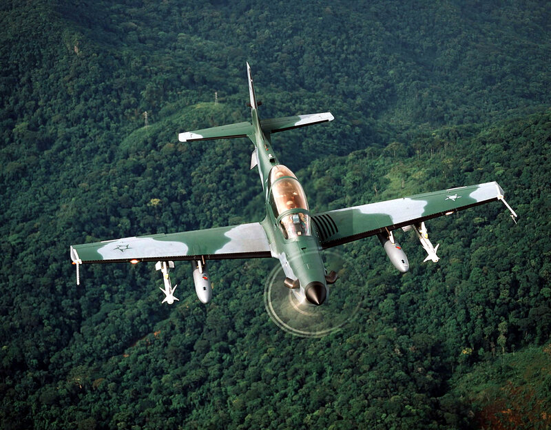 Green military jet in flight