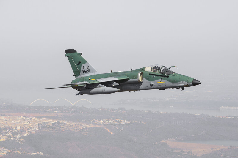 Green military jet in flight
