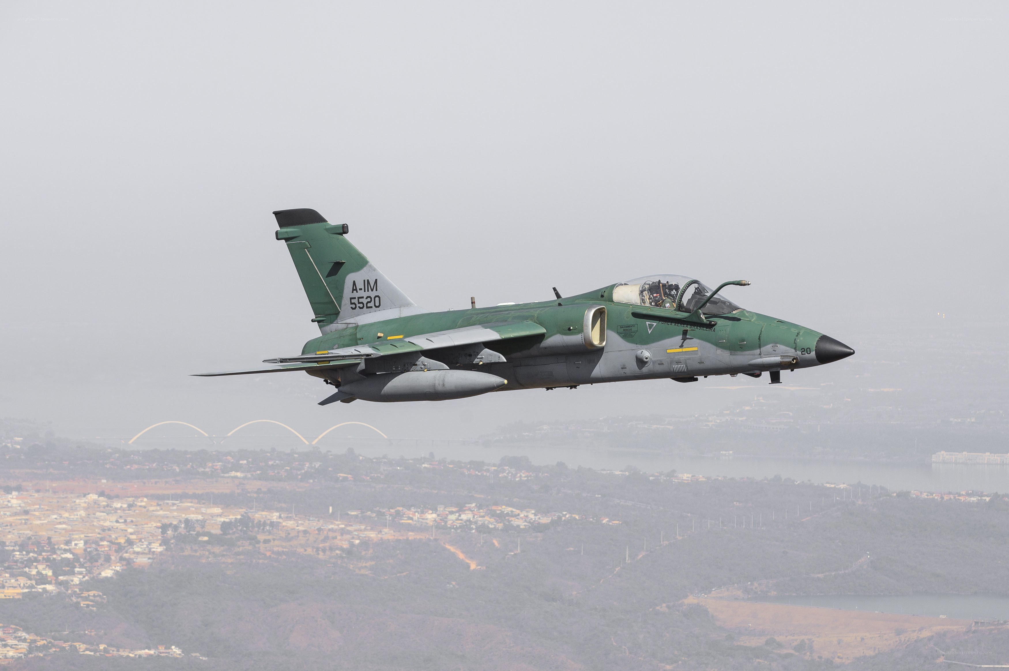 Green military jet in flight
