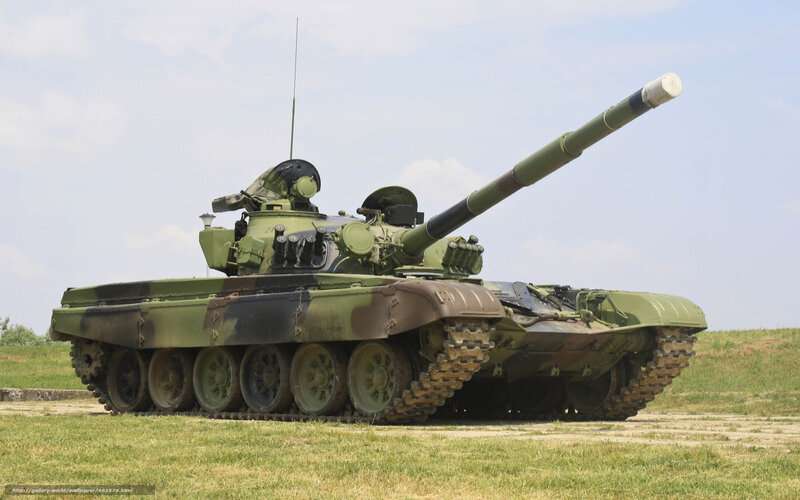 Green military tank on grass