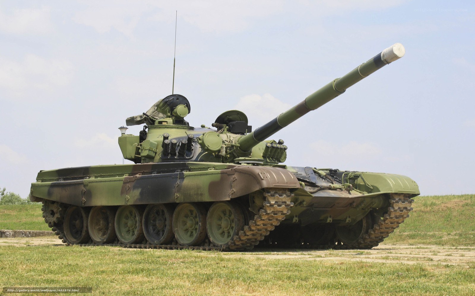 Green military tank on grass
