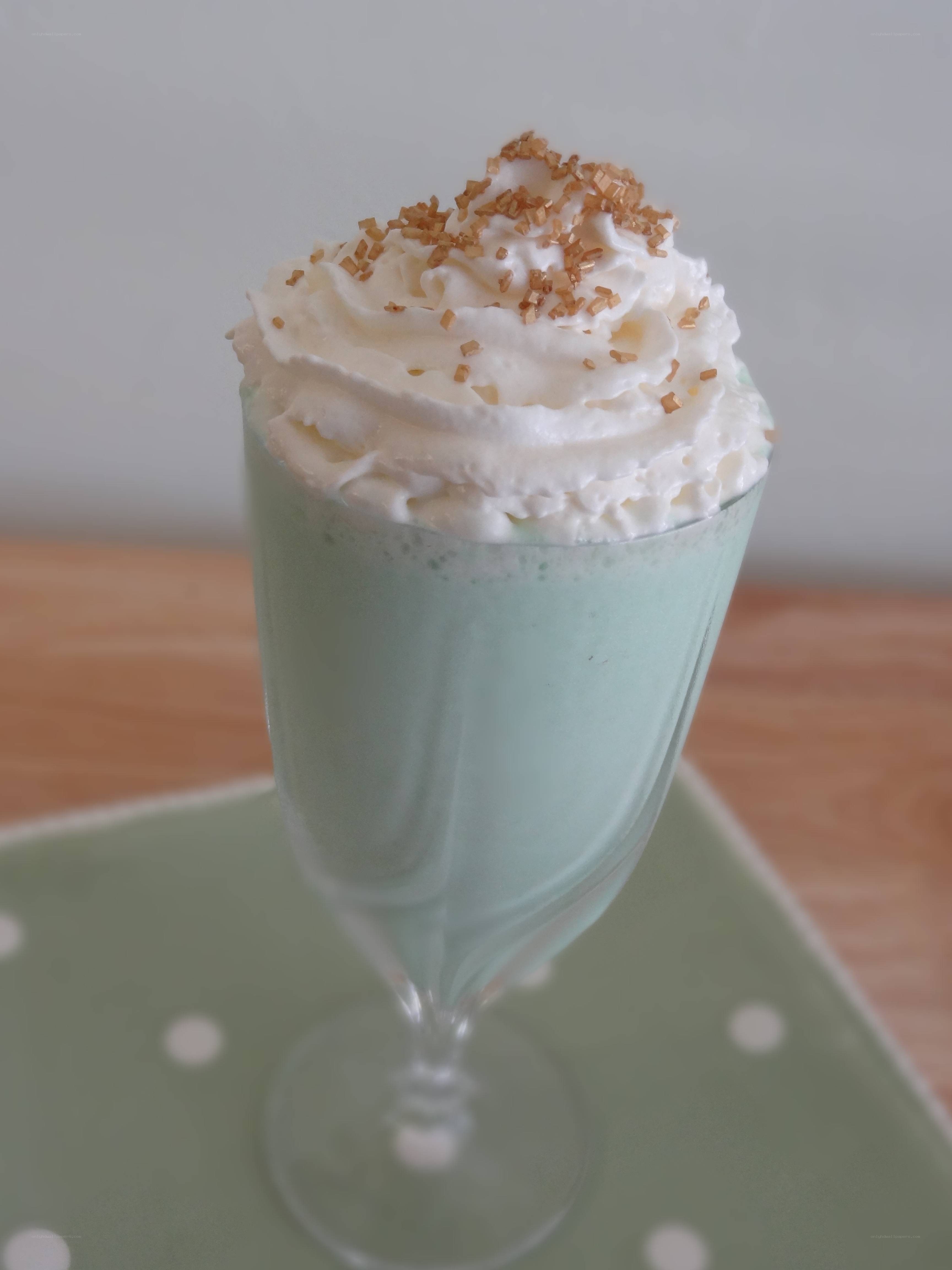 green milkshake with whipped cream