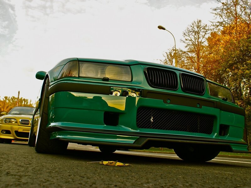 Green modified car on street