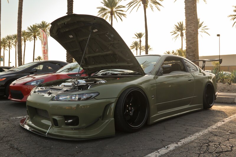Green modified sports car at a show