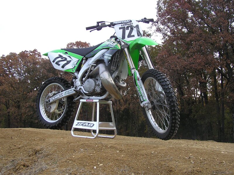 green motocross bike on stand
