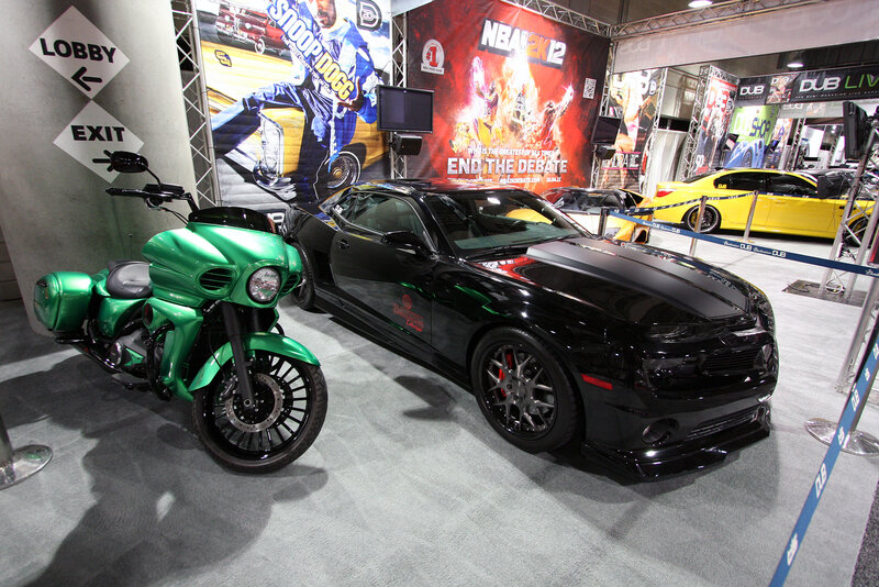 Green Motorcycle and Black Car