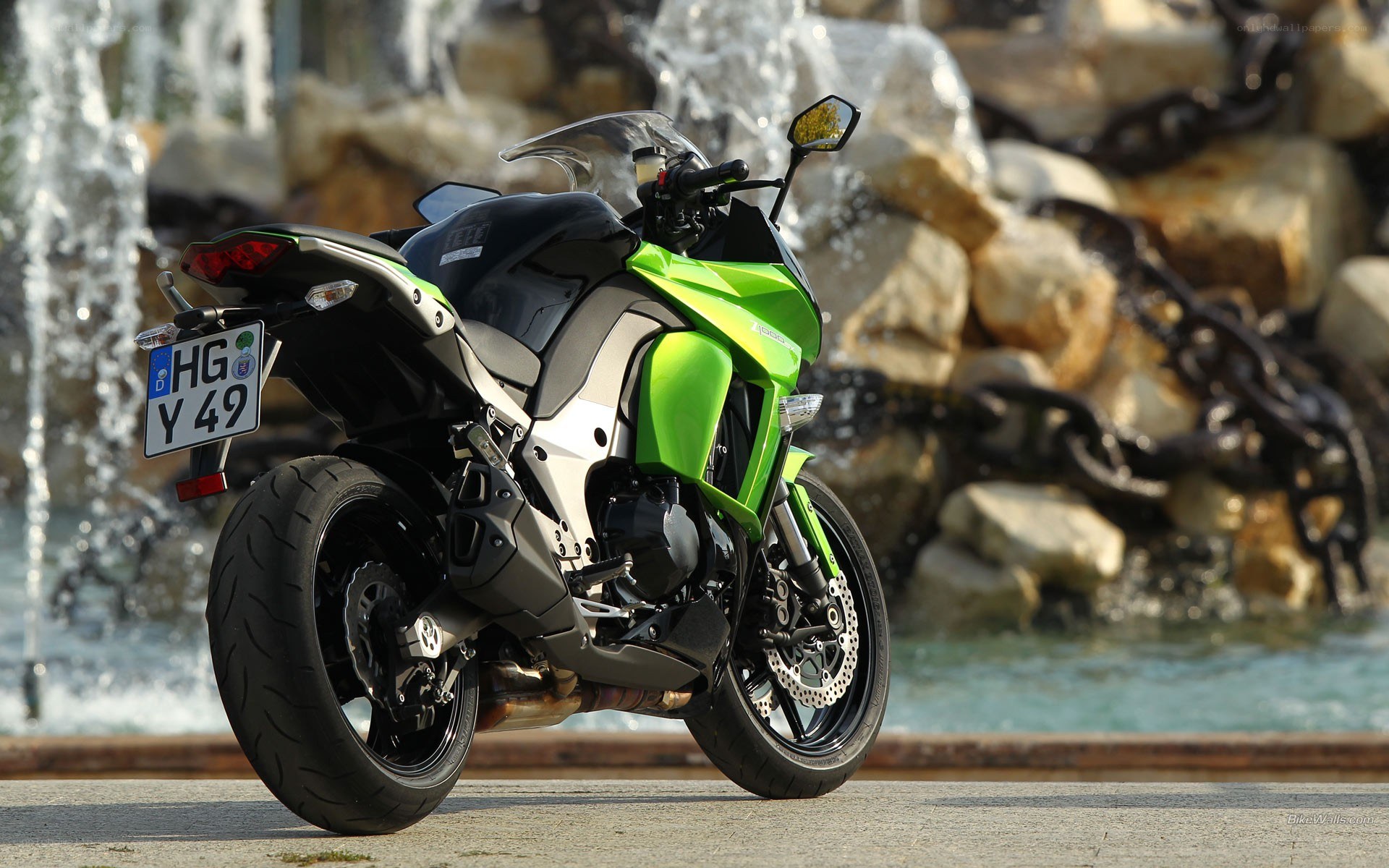 green motorcycle by fountain