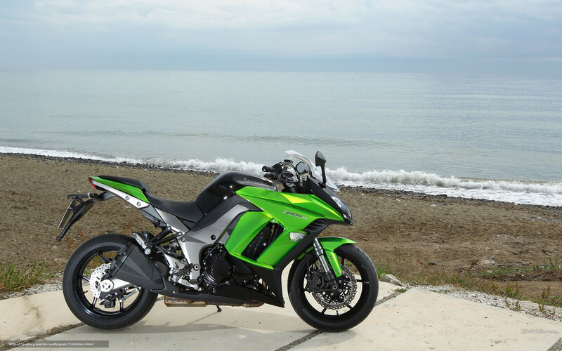 Green motorcycle on beach