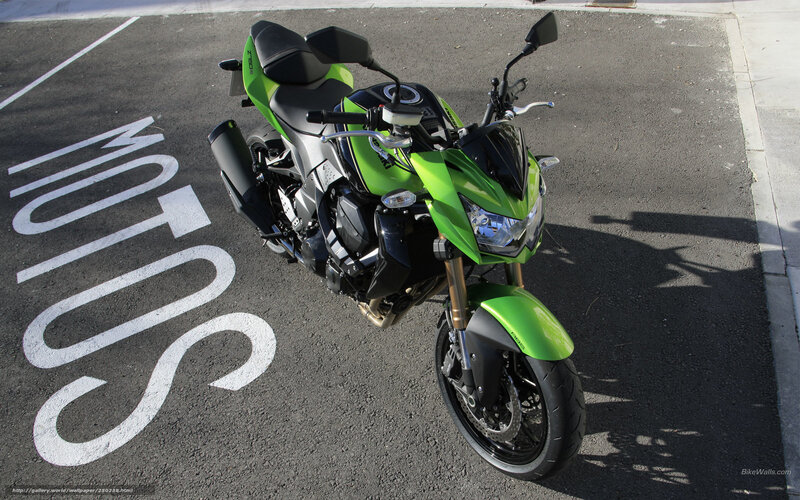 green motorcycle on pavement