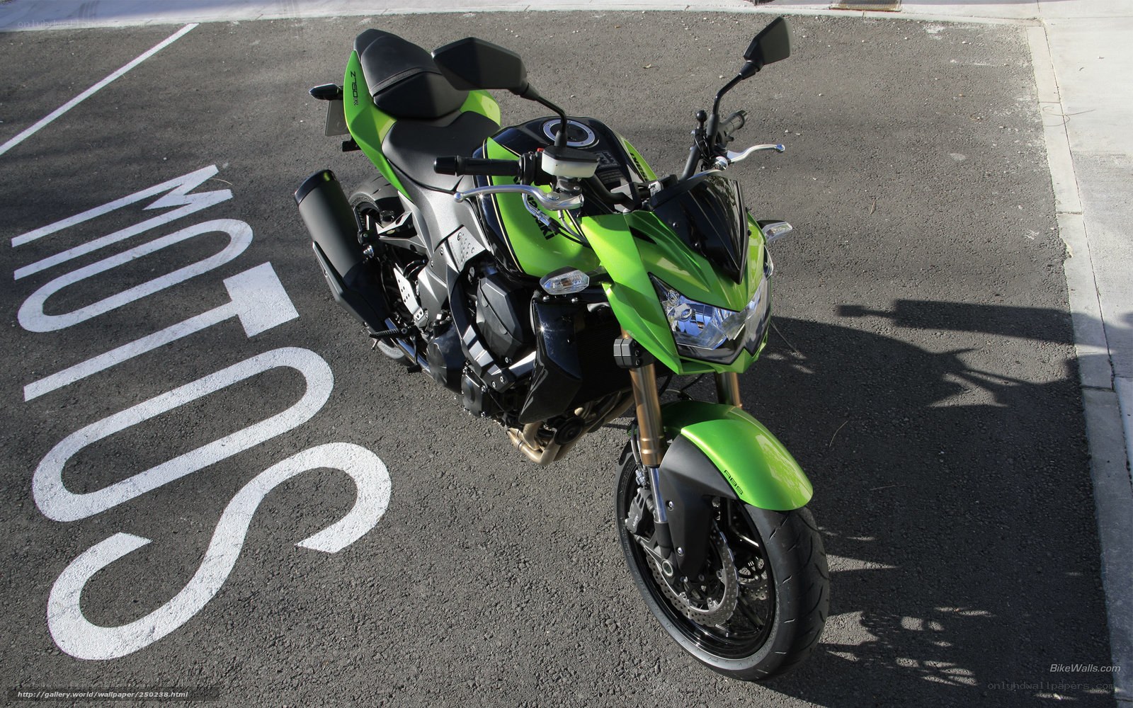 green motorcycle on pavement