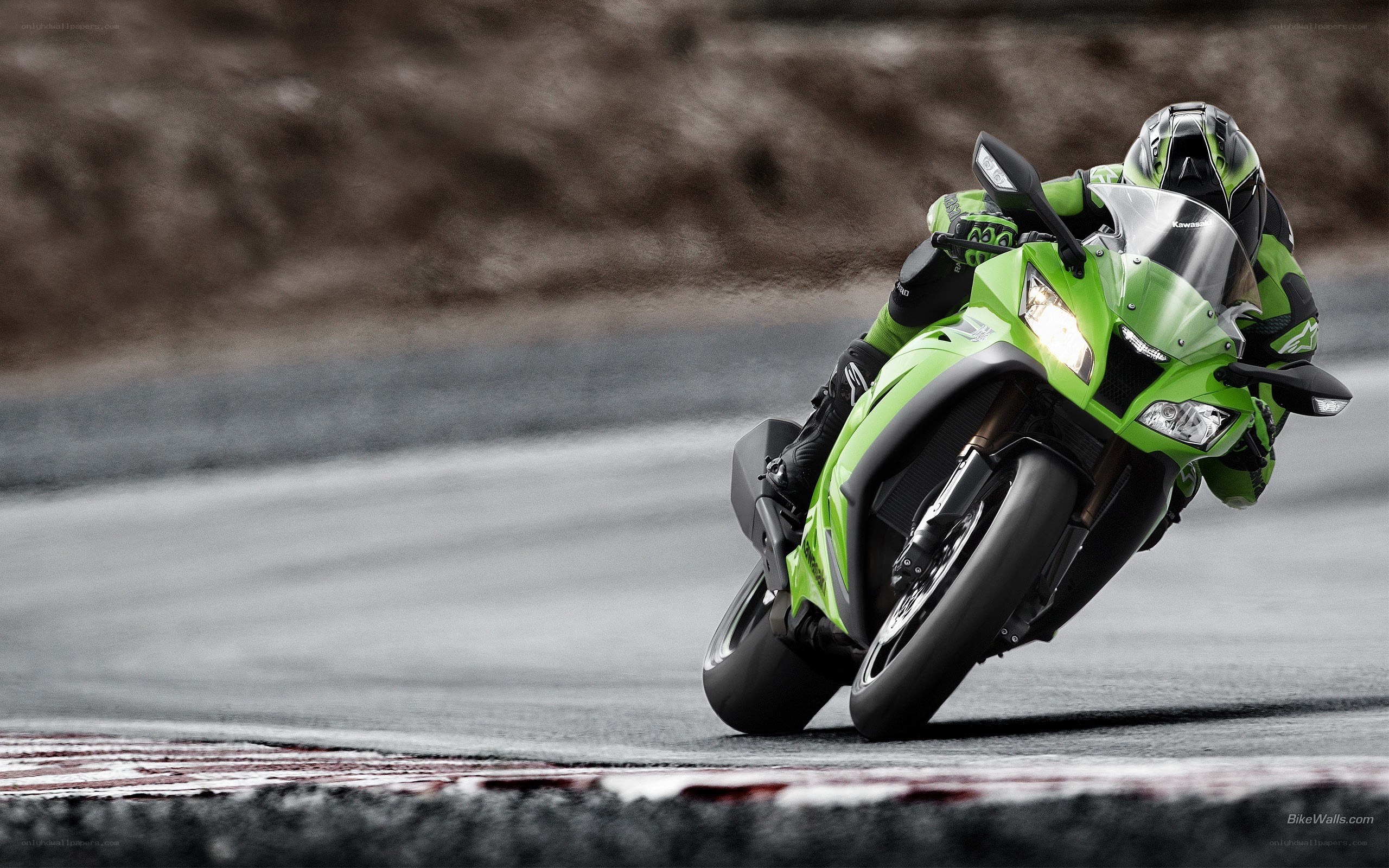 green motorcycle on racetrack