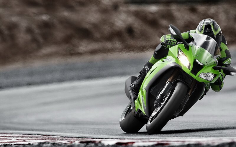 Green motorcycle on racetrack