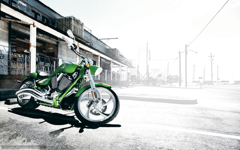 green motorcycle on street