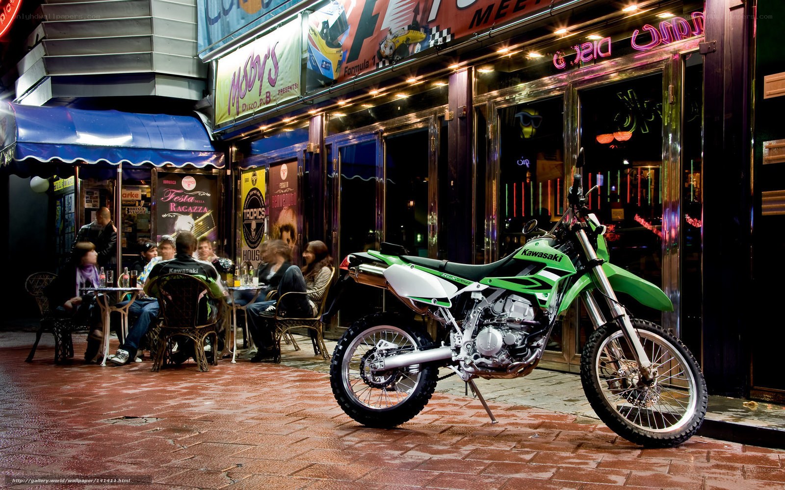 Green motorcycle outside nightclub