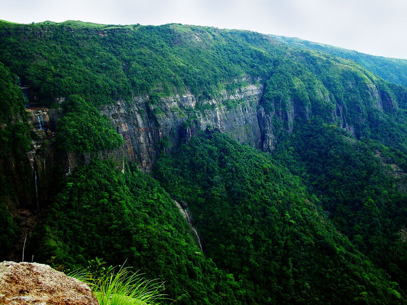 Green mountain cliffs with waterfalls