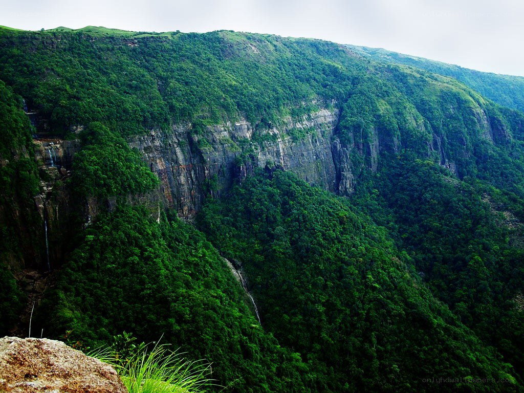 Green mountain cliffs with waterfalls