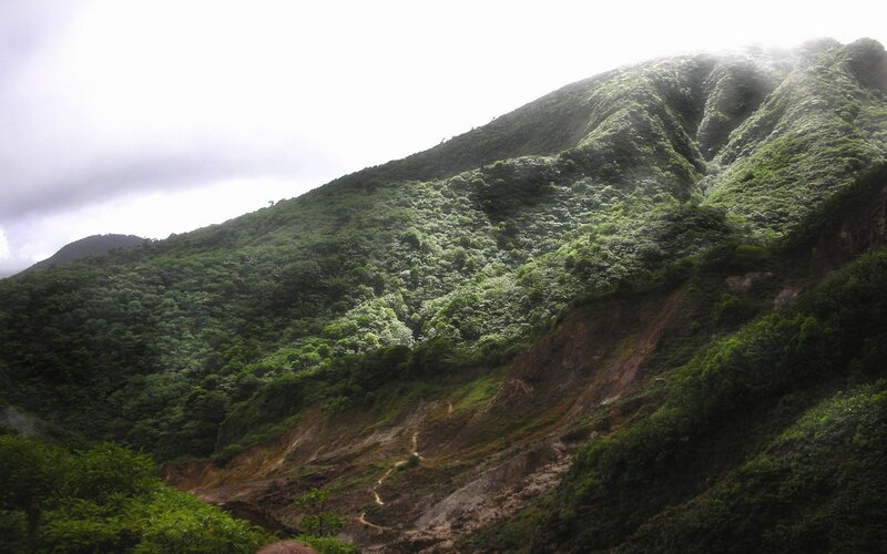 green mountain slope with landslide