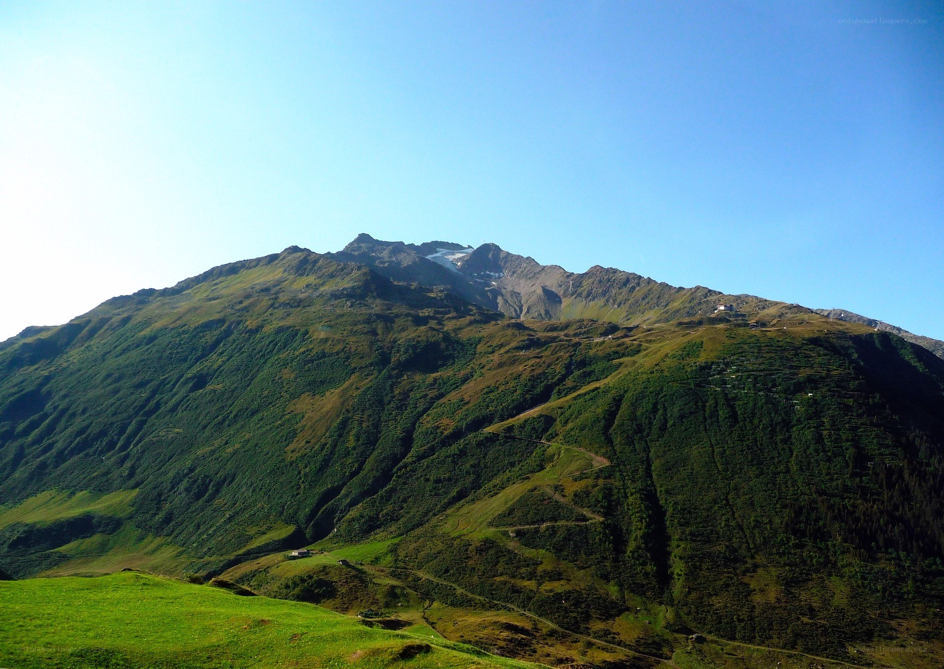 Green mountain under blue sky