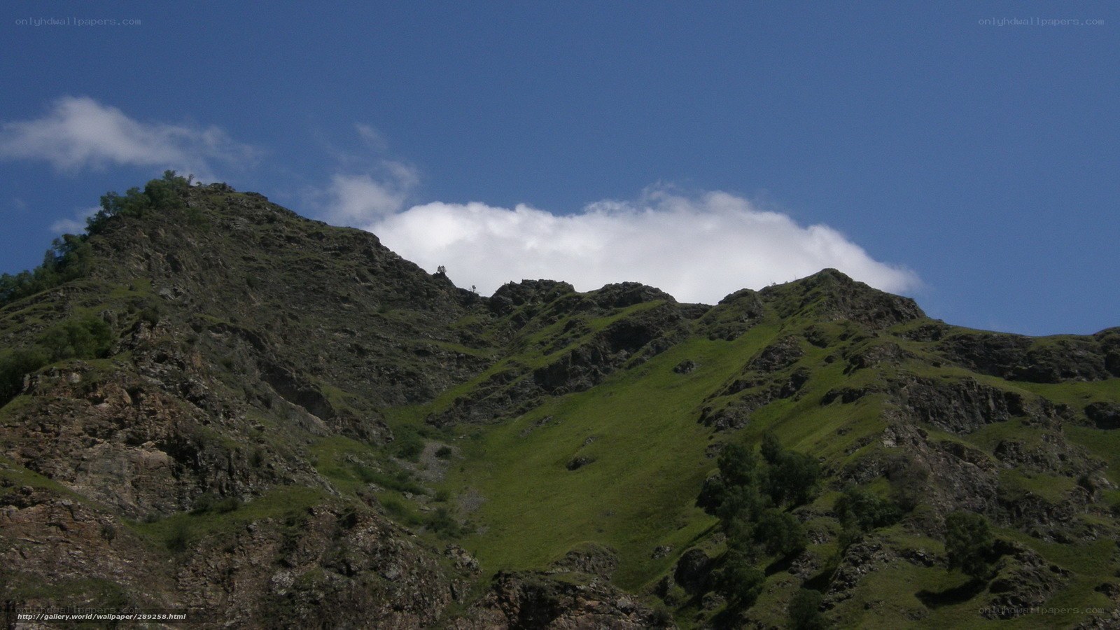 Green mountain under blue sky