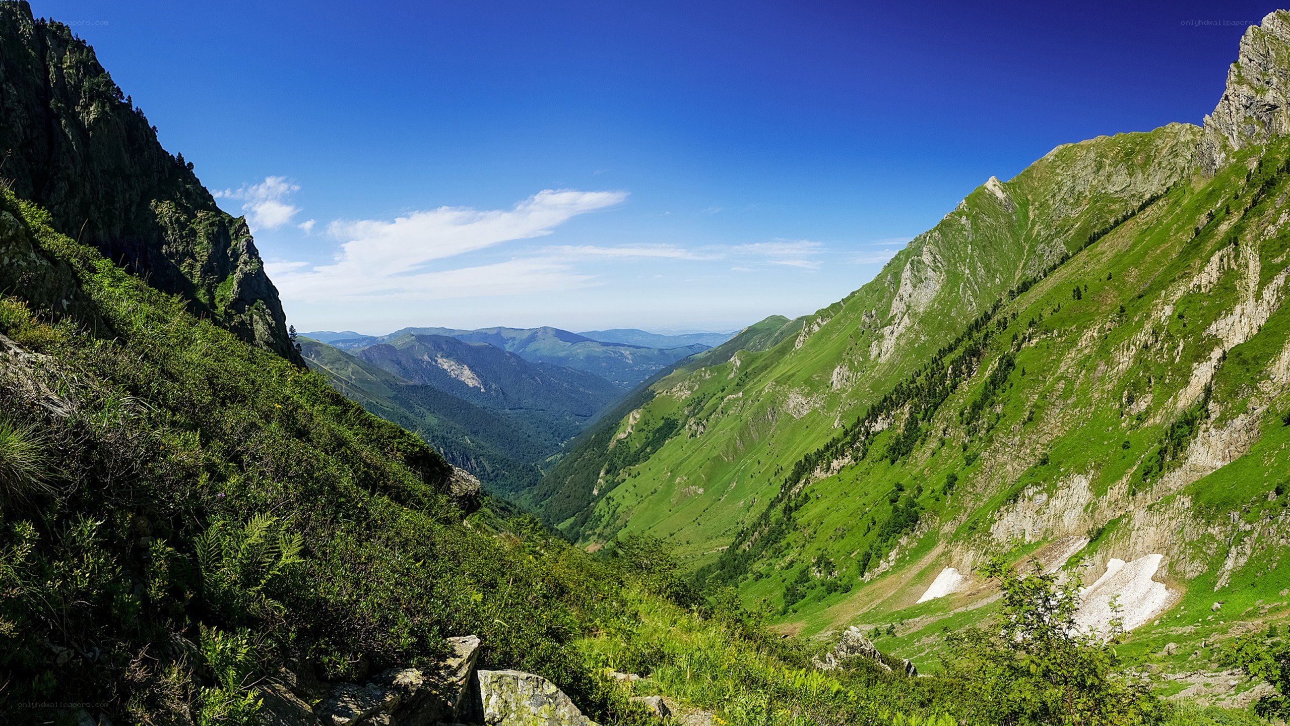 Green mountain valley under blue sky