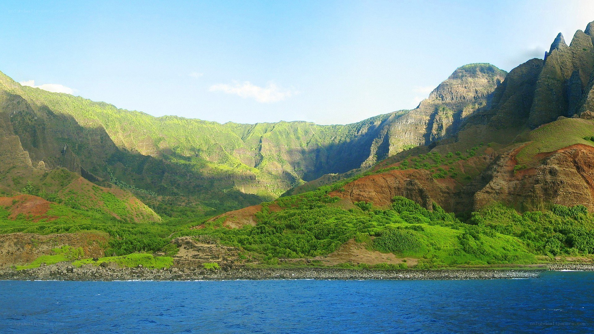 green mountains by the ocean