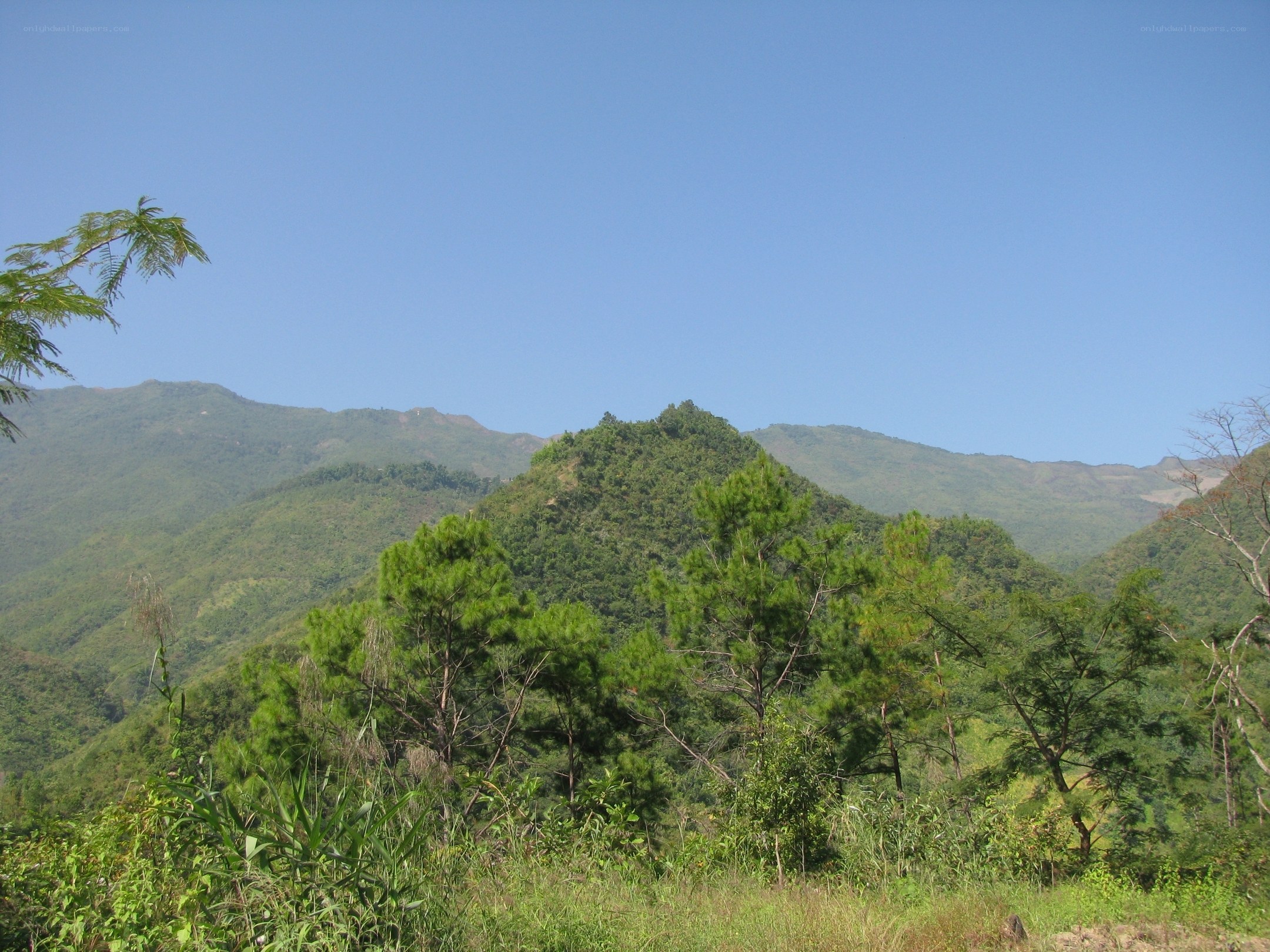 Green mountains under blue sky