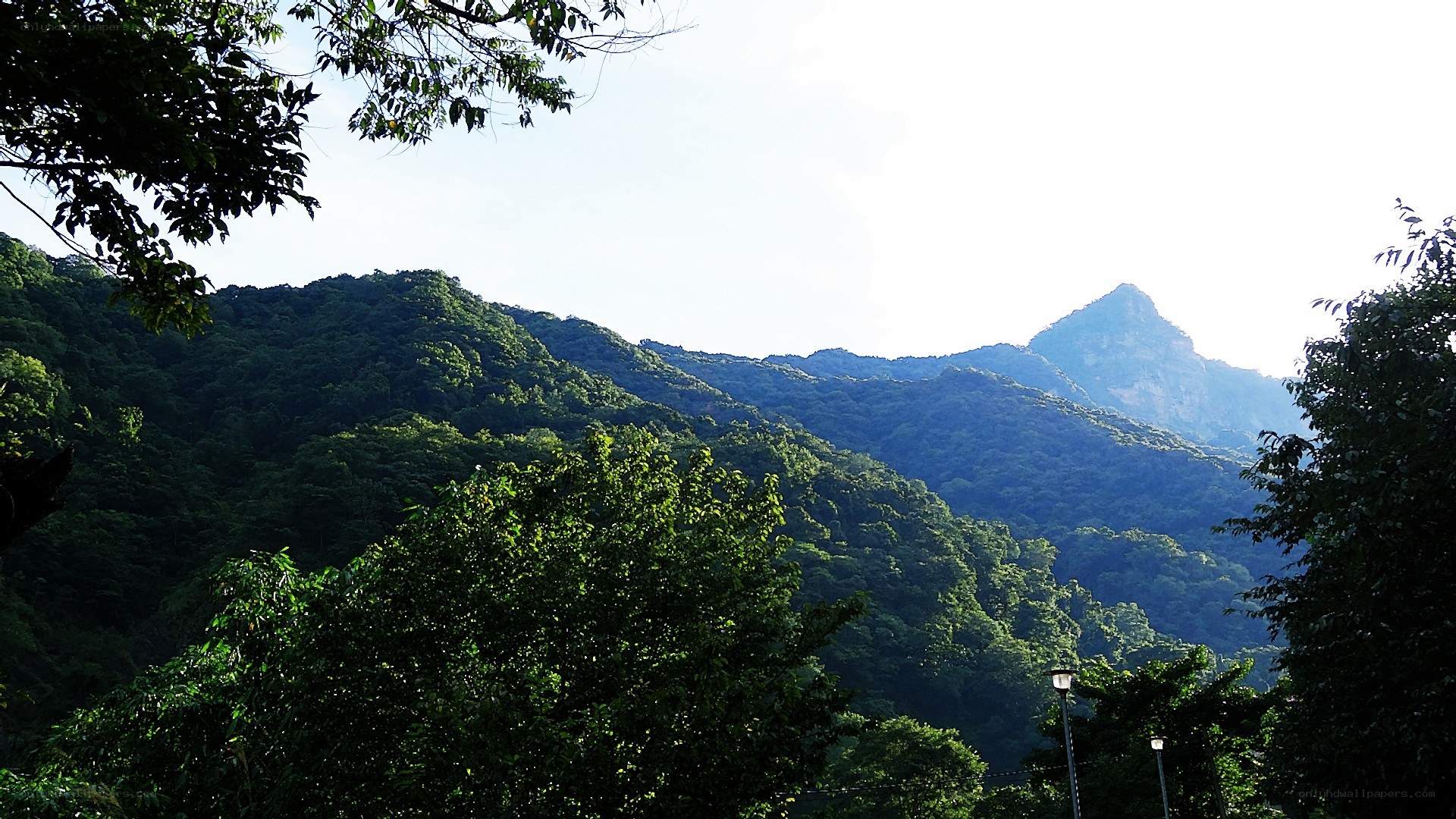 green mountains under bright sky