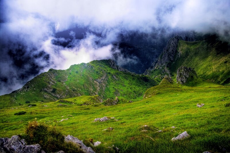 Green mountains under cloudy sky