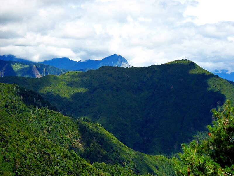 Green mountains under cloudy sky