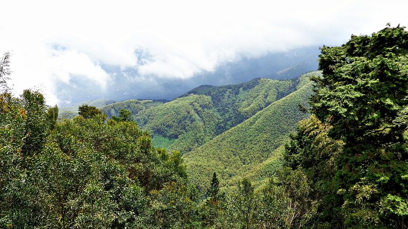 green mountains under cloudy sky