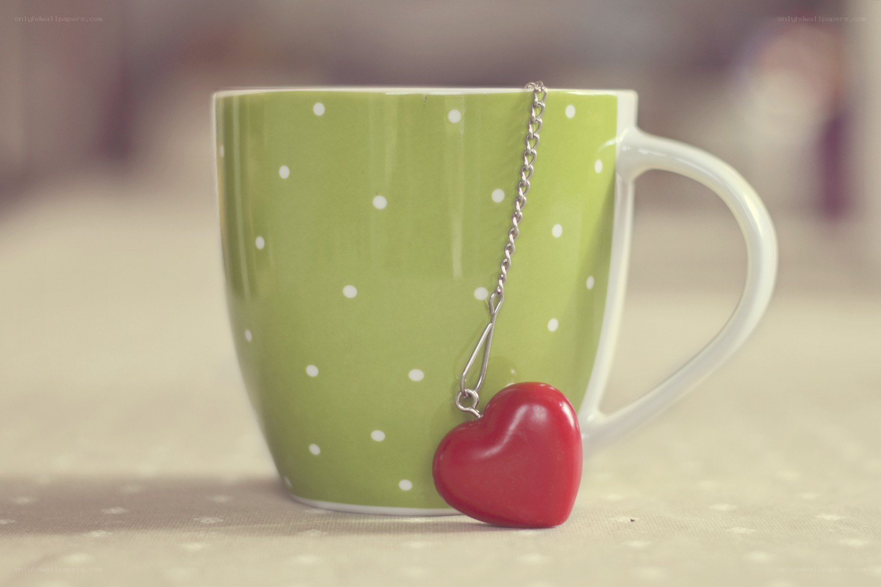green mug with heart tea infuser