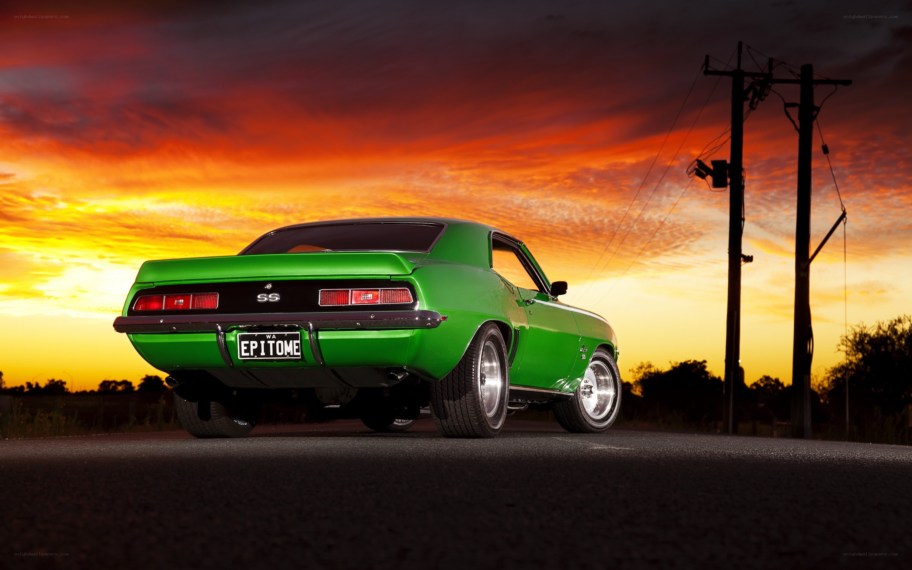 Green muscle car at sunset