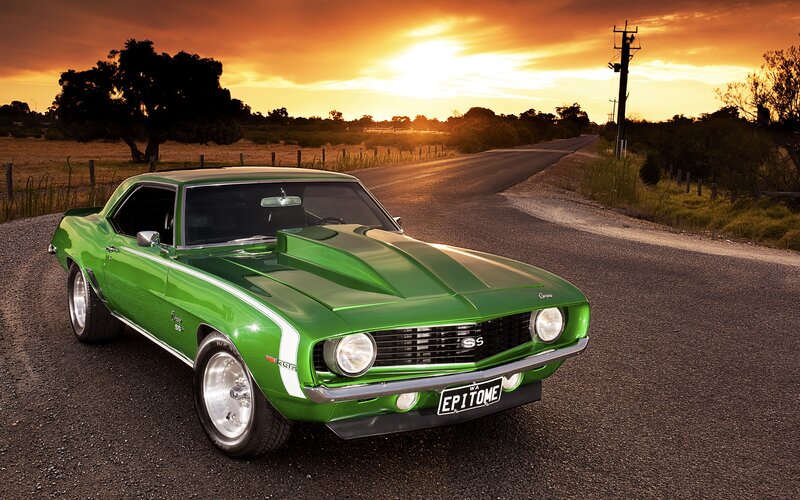 Green muscle car at sunset