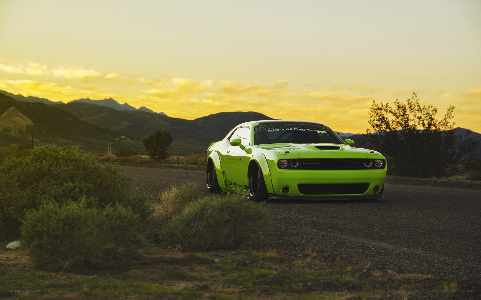 Green muscle car at sunset