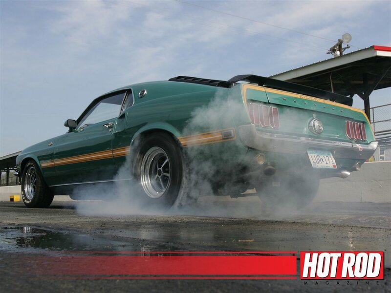 Green muscle car burnout