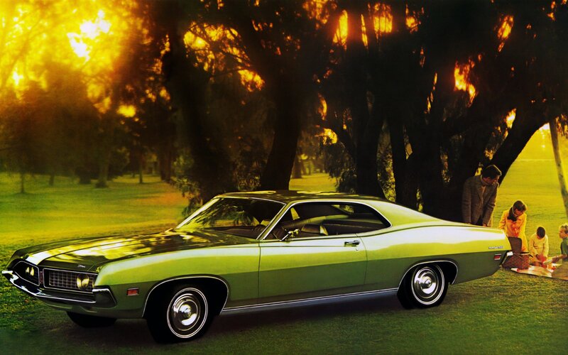 Green muscle car in park