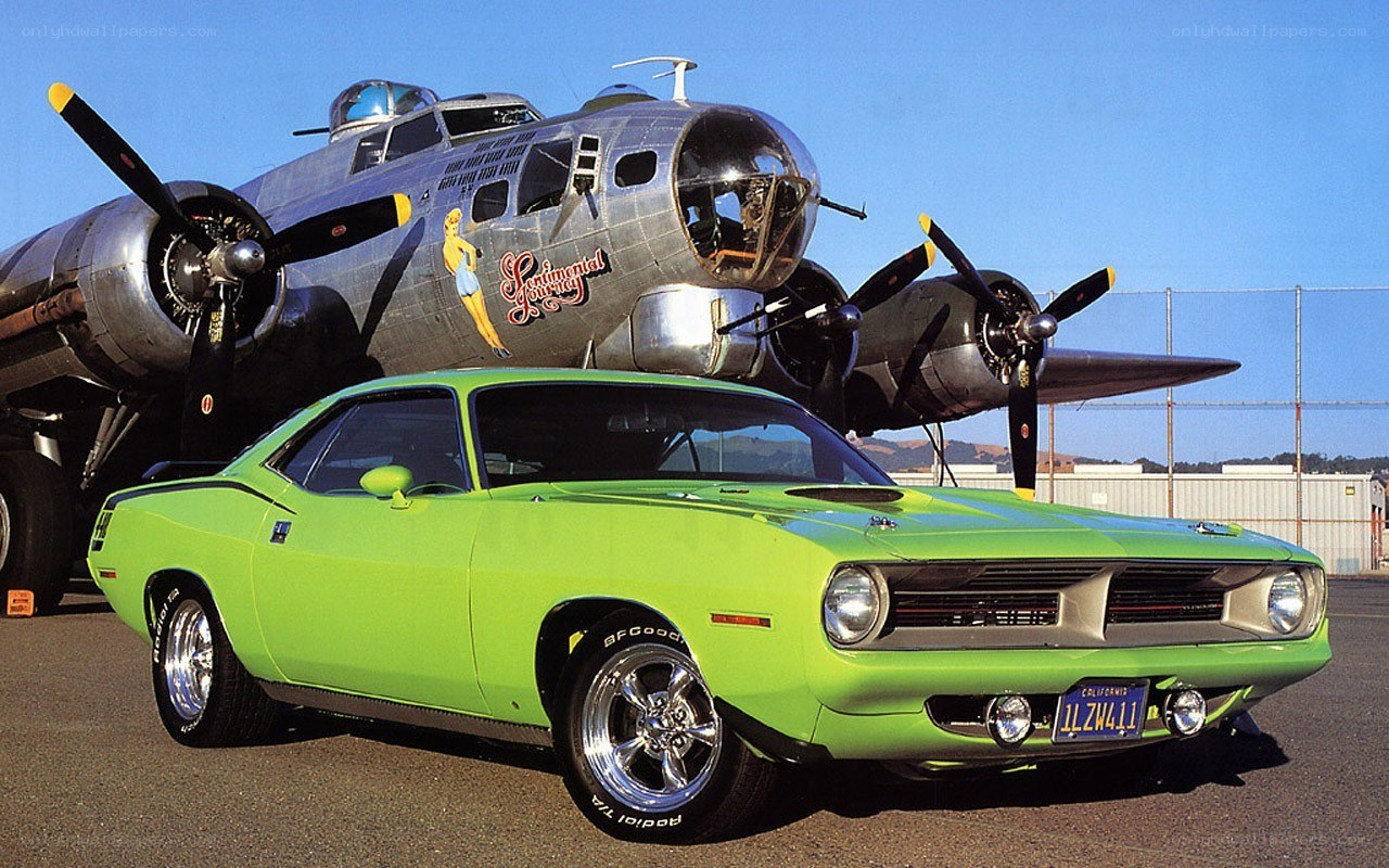 Green muscle car with bomber plane