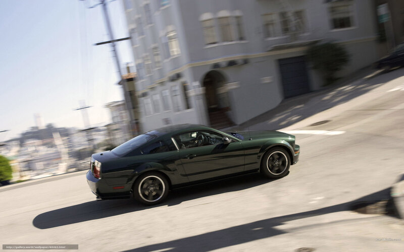green mustang on city street