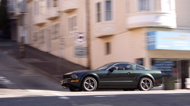 green mustang on city street