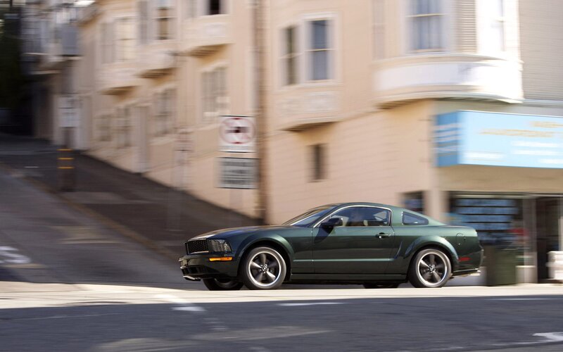 green mustang on city street