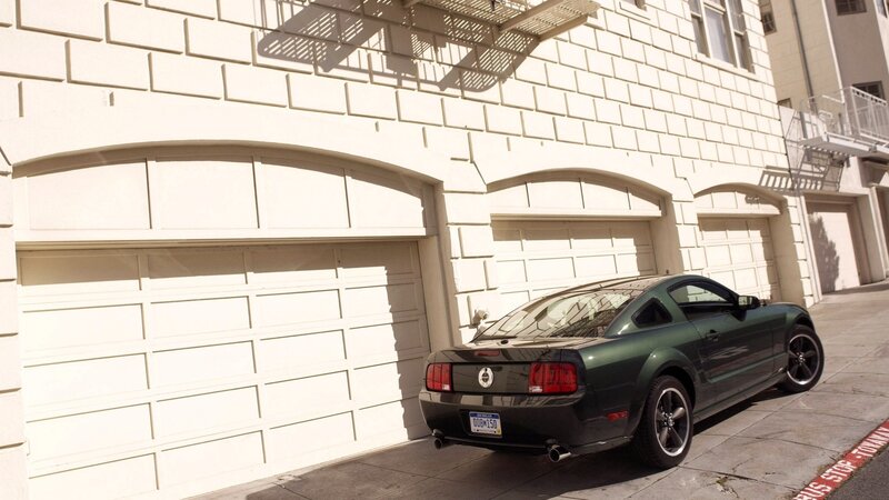 Green Mustang parked on street