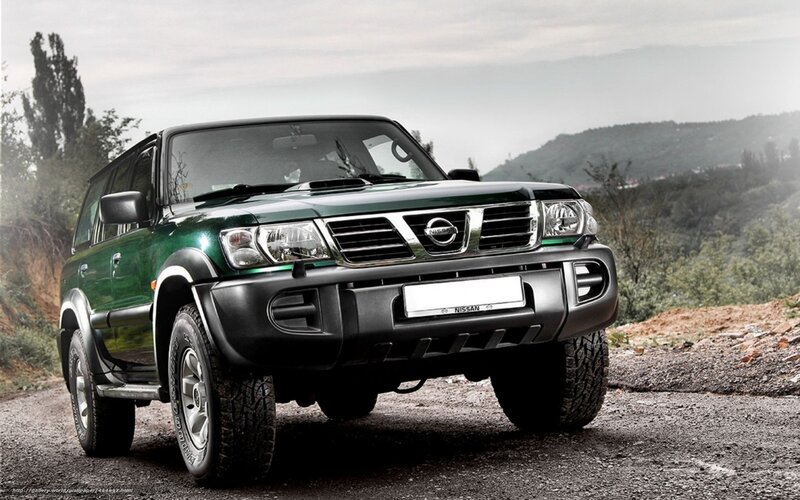 Green Nissan Patrol on gravel road