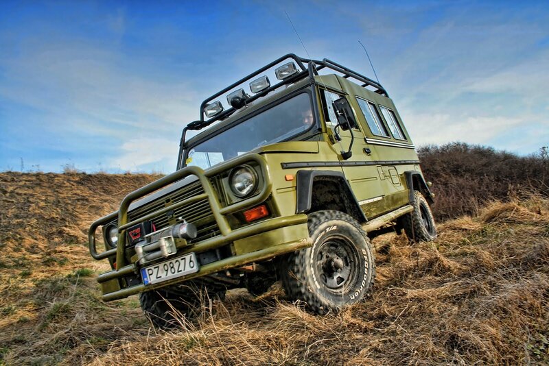 Green off-road vehicle on a hill