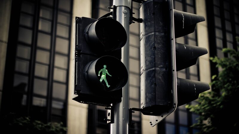 green pedestrian light in city